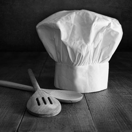 a chef hat and wooden spoons